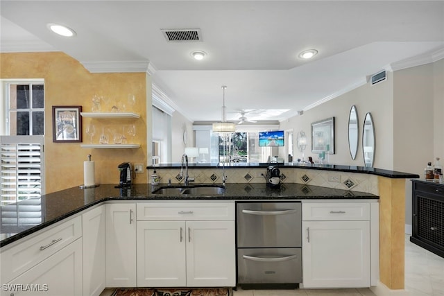 kitchen featuring sink, white cabinetry, dark stone countertops, light tile patterned flooring, and kitchen peninsula