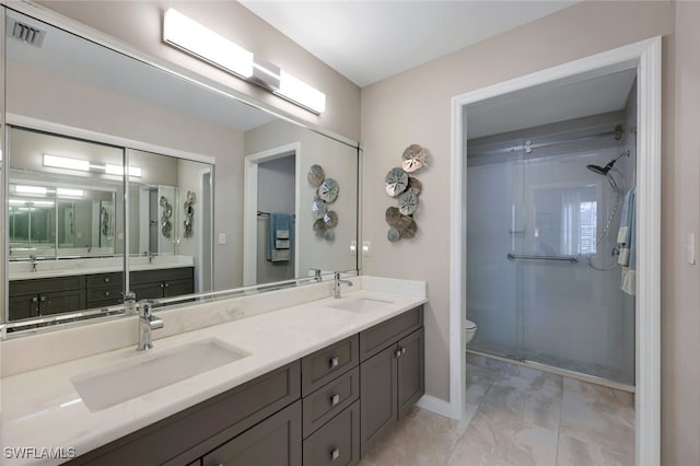 651 Wiggins Lake Dr Unit 101, Naples, FL 34110 - bathroom with marble finish floors, double vanity, and a shower stall