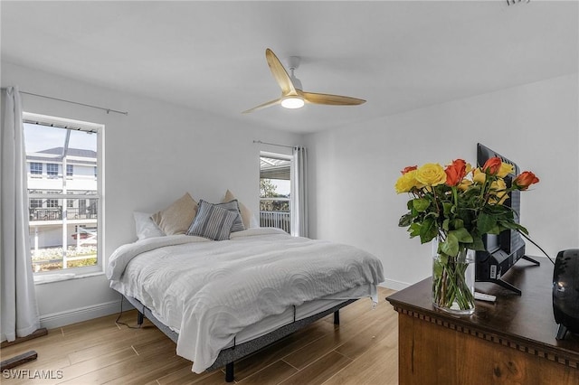 bedroom with hardwood / wood-style floors and ceiling fan