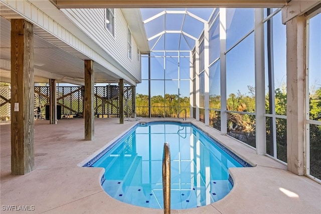 view of swimming pool featuring a patio and glass enclosure