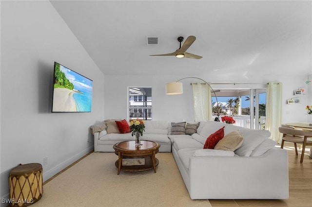 living room featuring lofted ceiling, plenty of natural light, and ceiling fan