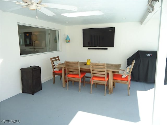 dining room featuring ceiling fan and concrete flooring