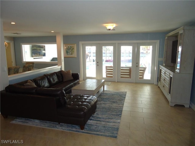 tiled living room with french doors and a healthy amount of sunlight