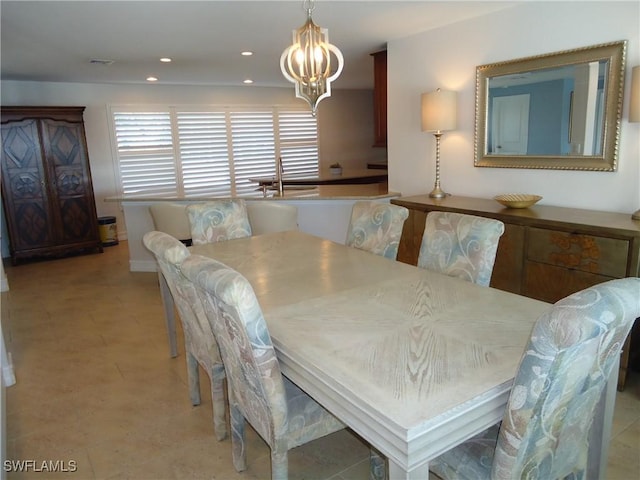 dining space featuring a notable chandelier