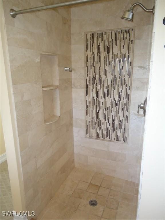 bathroom with tiled shower