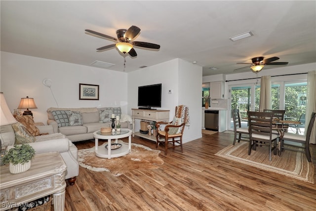 living room with hardwood / wood-style flooring and ceiling fan