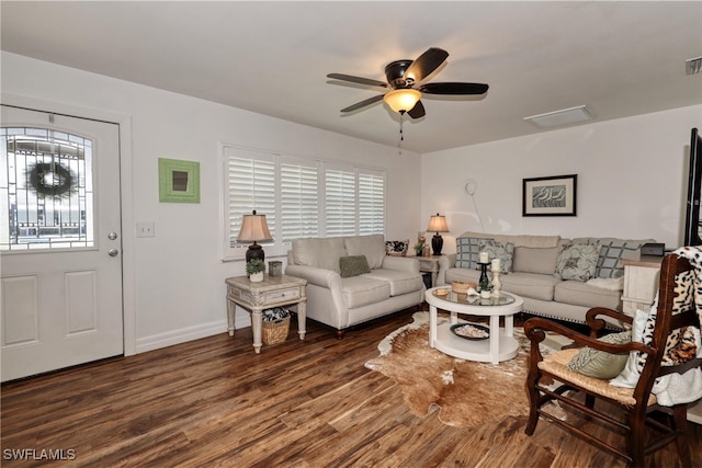 living room featuring ceiling fan and dark wood-type flooring