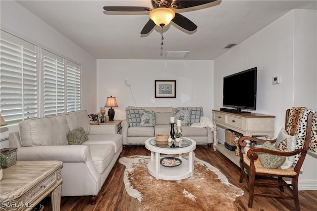 living room featuring ceiling fan and dark hardwood / wood-style floors