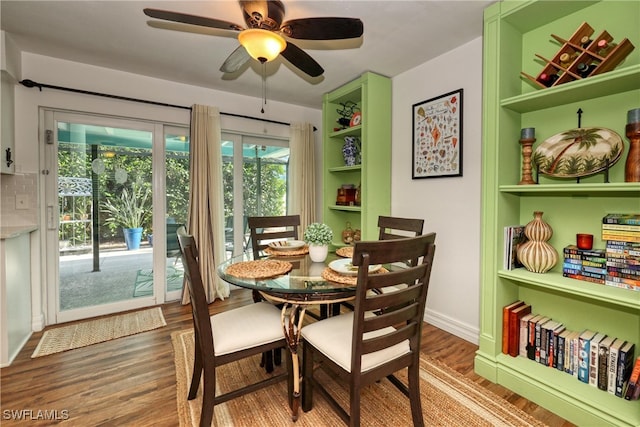 dining area featuring built in features, ceiling fan, and hardwood / wood-style floors