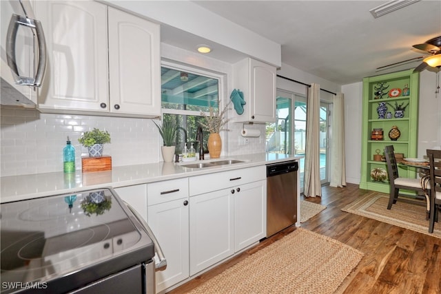 kitchen featuring stainless steel appliances, white cabinetry, and sink