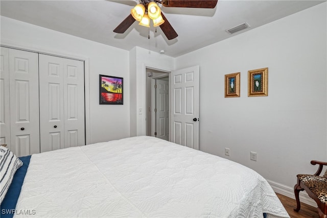 bedroom featuring ceiling fan, a closet, and hardwood / wood-style flooring