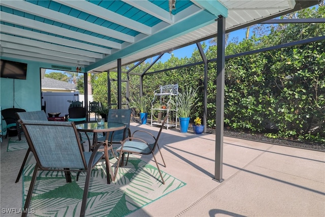 view of patio featuring a lanai