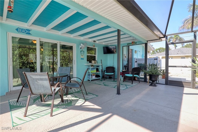 sunroom featuring beam ceiling