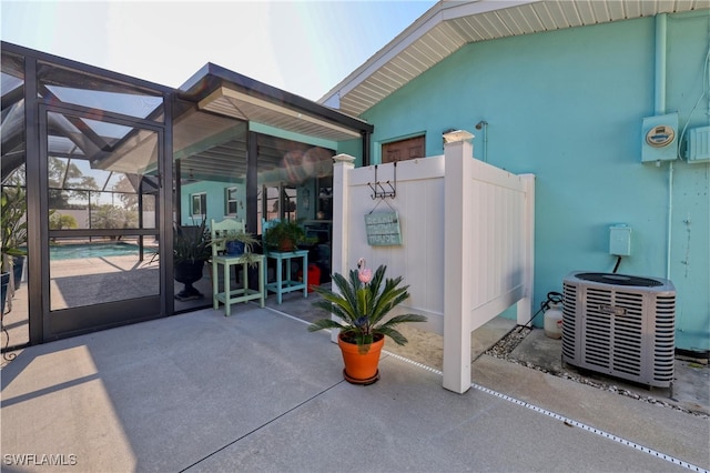 view of patio / terrace featuring a pool, a lanai, and cooling unit