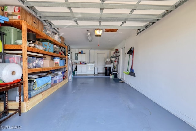 garage with washer and dryer and a garage door opener