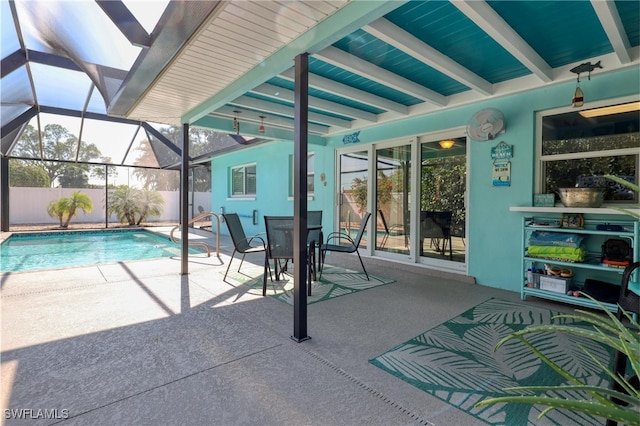 view of swimming pool featuring a lanai and a patio