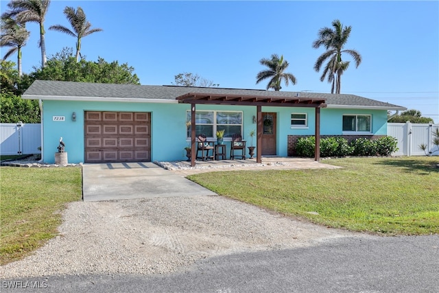 ranch-style house with a front yard, a garage, and covered porch