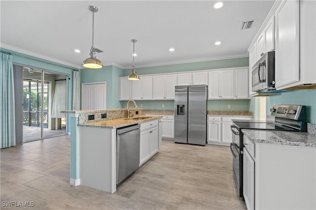 kitchen featuring pendant lighting, a center island with sink, sink, white cabinetry, and stainless steel appliances