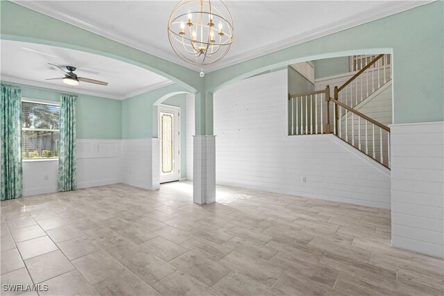 empty room with crown molding and ceiling fan with notable chandelier