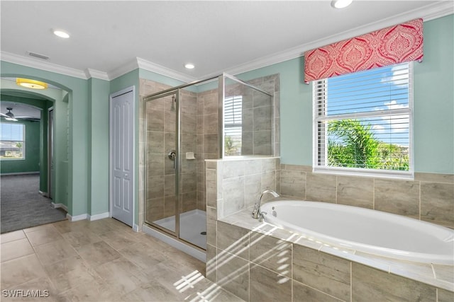 bathroom featuring a shower stall, a bath, and crown molding