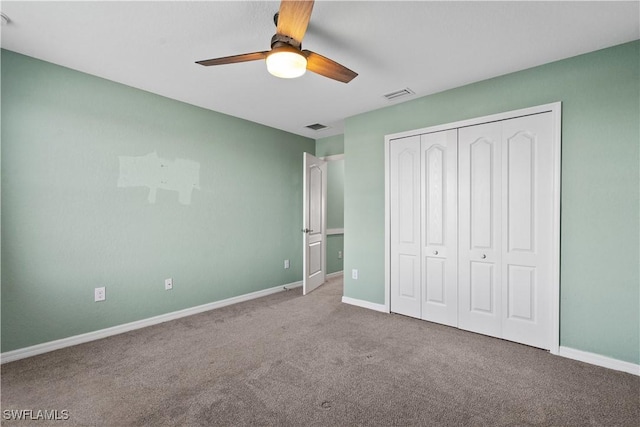 unfurnished bedroom with carpet floors, a closet, and ceiling fan