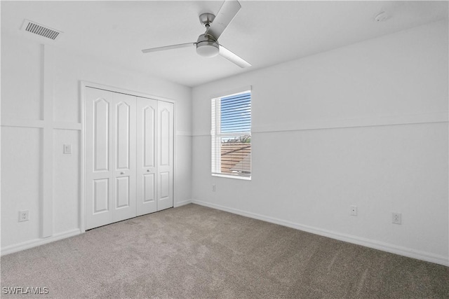 unfurnished bedroom with a ceiling fan, visible vents, baseboards, a closet, and carpet flooring