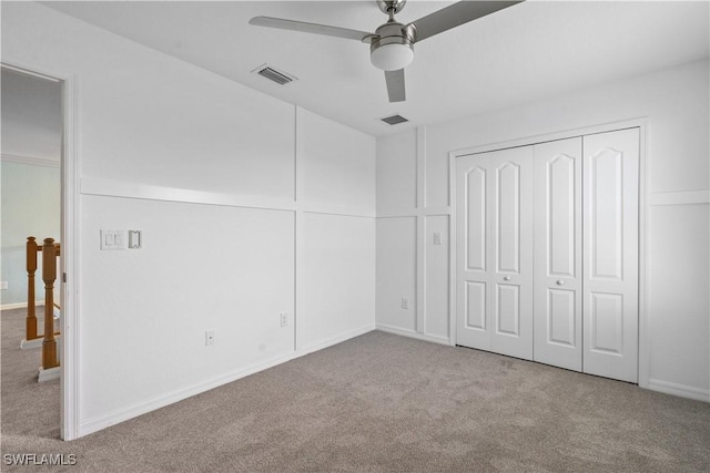 unfurnished bedroom featuring ceiling fan, light carpet, and a closet