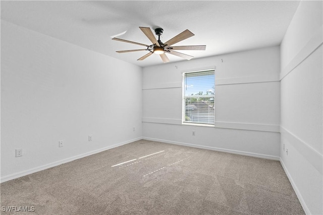 empty room featuring baseboards, carpet, and a ceiling fan