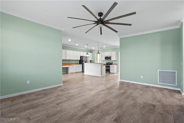 unfurnished living room with a ceiling fan, baseboards, visible vents, crown molding, and light wood-type flooring