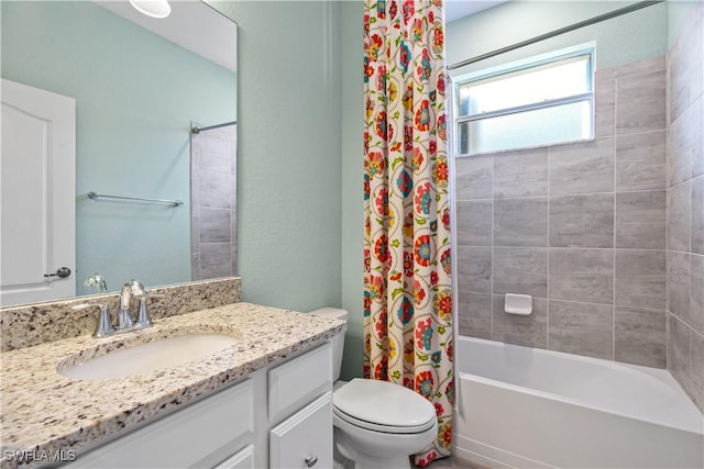 full bathroom with vanity, toilet, and shower / tub combo with curtain