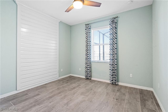 empty room with ceiling fan and light wood-type flooring