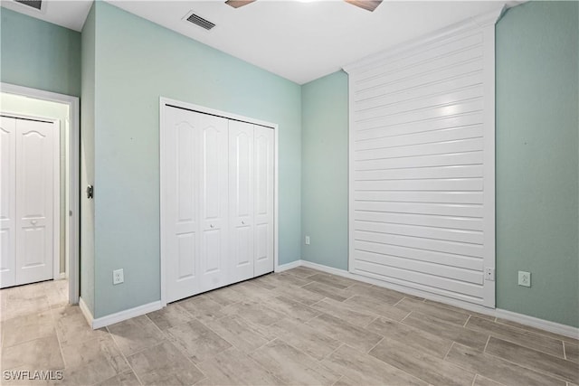 unfurnished bedroom featuring a closet, visible vents, ceiling fan, and baseboards