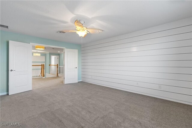 unfurnished bedroom with ceiling fan and light carpet