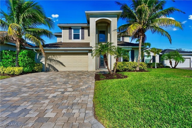 view of front facade featuring a garage and a front lawn