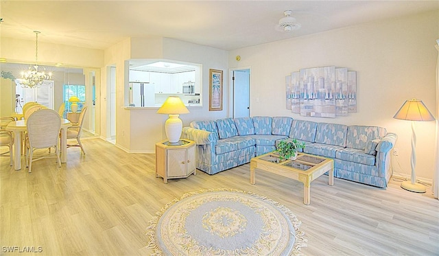 living room featuring hardwood / wood-style floors and an inviting chandelier