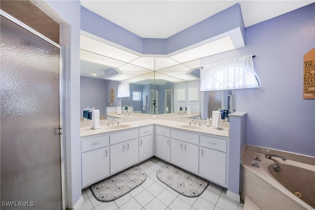 bathroom with tile patterned floors, vanity, and shower with separate bathtub