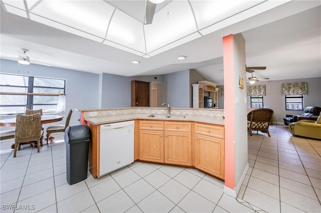 kitchen featuring ceiling fan, sink, kitchen peninsula, white dishwasher, and light tile patterned floors