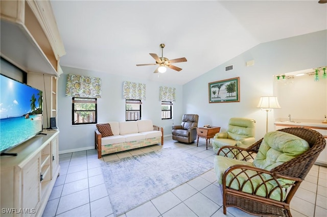 living room with light tile patterned floors, lofted ceiling, and a healthy amount of sunlight