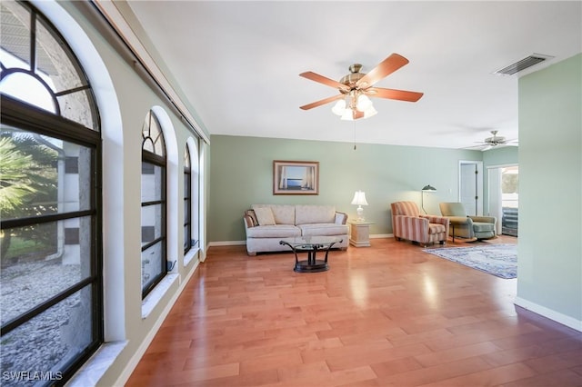 living room featuring ceiling fan and light wood-type flooring