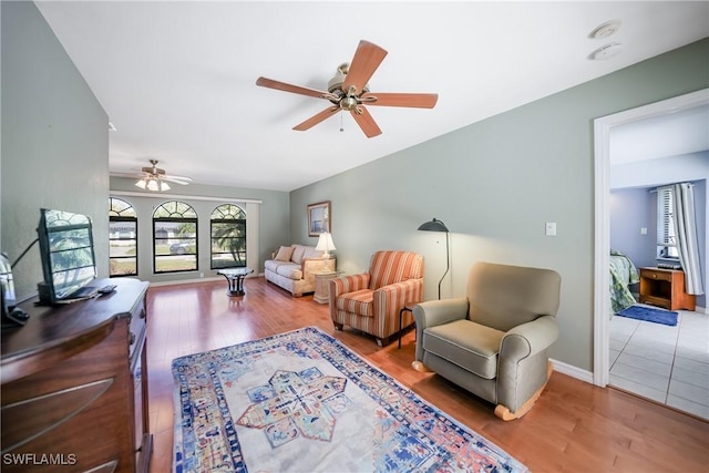 living room with hardwood / wood-style flooring and ceiling fan