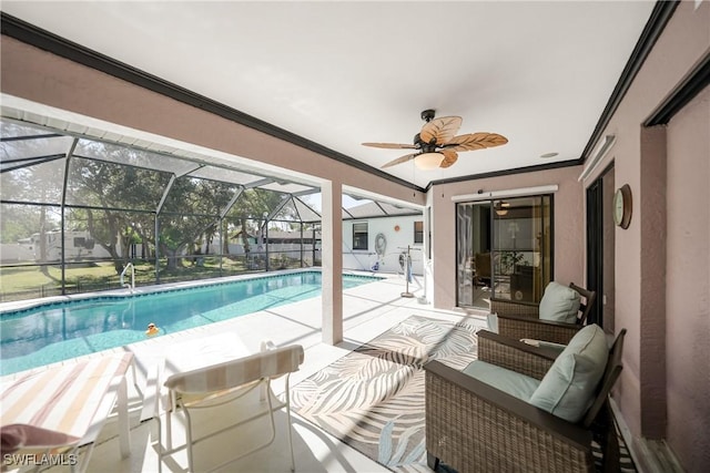 view of swimming pool with glass enclosure, ceiling fan, and a patio