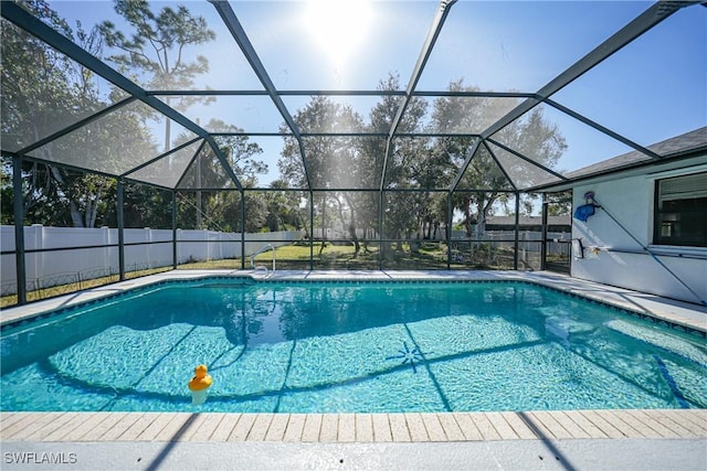 view of swimming pool with glass enclosure