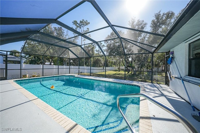 view of swimming pool featuring glass enclosure and a patio area