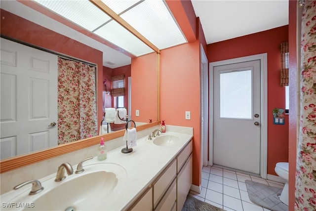 bathroom featuring tile patterned flooring, vanity, and toilet