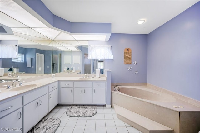 bathroom with tile patterned flooring, vanity, and a bath