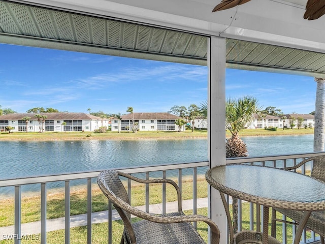 interior space with ceiling fan and a water view