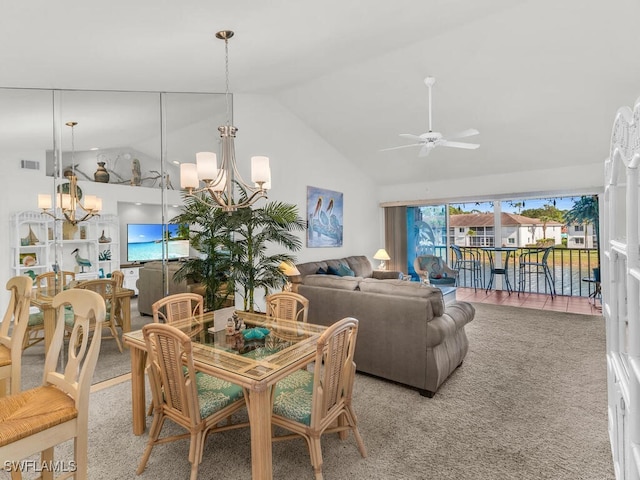 dining space featuring ceiling fan with notable chandelier, carpet floors, and lofted ceiling