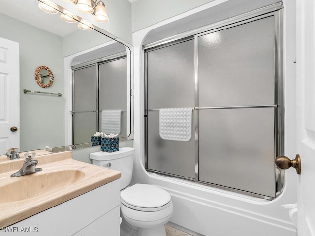 full bathroom featuring vanity, enclosed tub / shower combo, a notable chandelier, and toilet