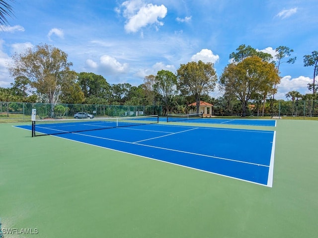 view of tennis court with basketball hoop