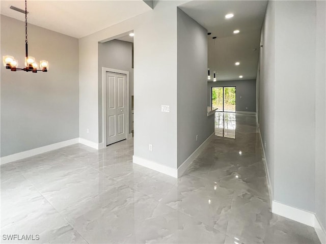 corridor with an inviting chandelier